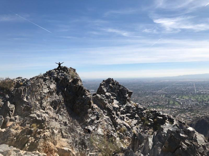 Tracey Nguyen pictured in the distance on top of a mountain in Arizona.