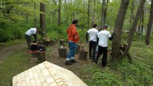 Three Voya volunteers at a tree planting event.