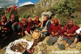 Wade Davis with a group of Tibetan men in the mountains.