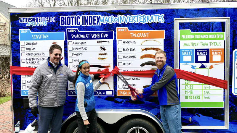 Executive Director David Arscott, Assistant Director of Education Tara Muenz, and Director of Education Steve Kerlin cut the ribbon on the new Watershed Education Mobile Lab.
