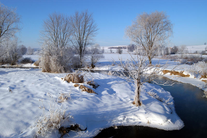 A meander of the Brandywine Creek with snow on the streambanks.